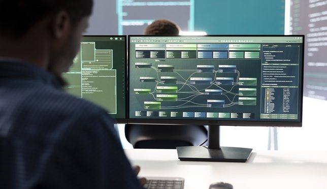 Governmental hacker expert securing computer systems from cyber attacks, working in monitoring center control room. Man focusing on encryption and espionage against cyber threats.